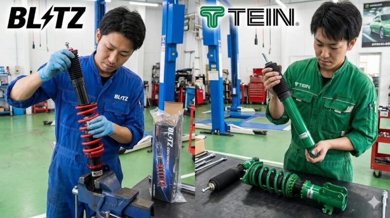 日本の整備工場で、左側はBLITZのカートリッジ交換作業、右側はTEINのリプレイスメントショック交換作業を行っている日本人メカニックの様子